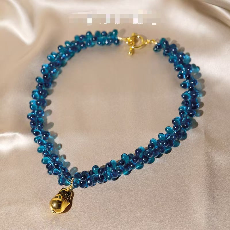 Fashion glass wide band bracelet with a gold teardrop pendant